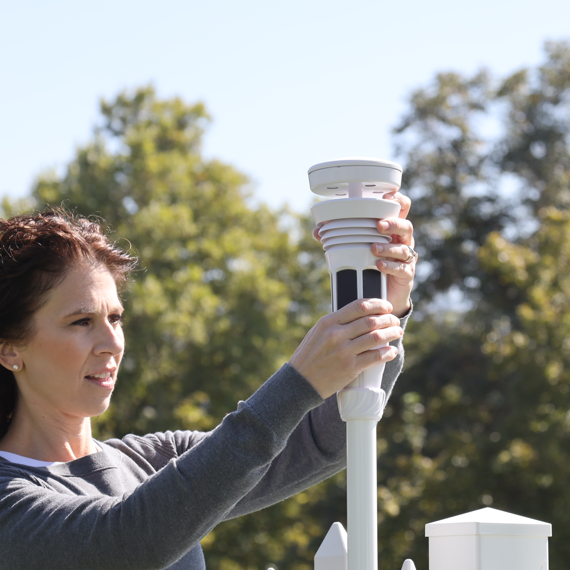 Woman mounting a Tempest in a yard.